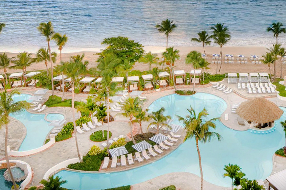 width_1560_pool-deck-aerial-with-beach